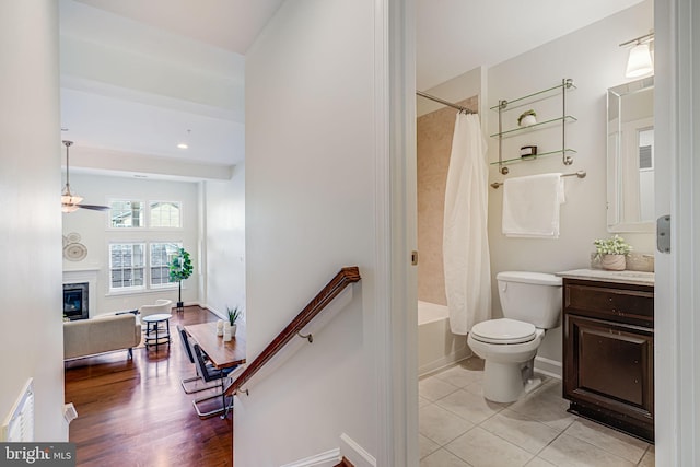 7817 Tilghman St, Fulton, MD 20759 - full bathroom featuring tile patterned floors, toilet, a glass covered fireplace, shower / bathtub combination with curtain, and vanity
