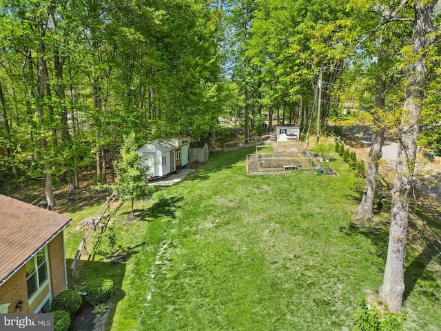 view of yard with a vegetable garden and an outbuilding