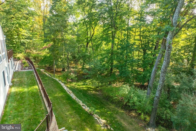 view of landscape featuring a forest view