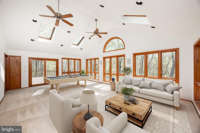 living area with a skylight, billiards, a wealth of natural light, and high vaulted ceiling