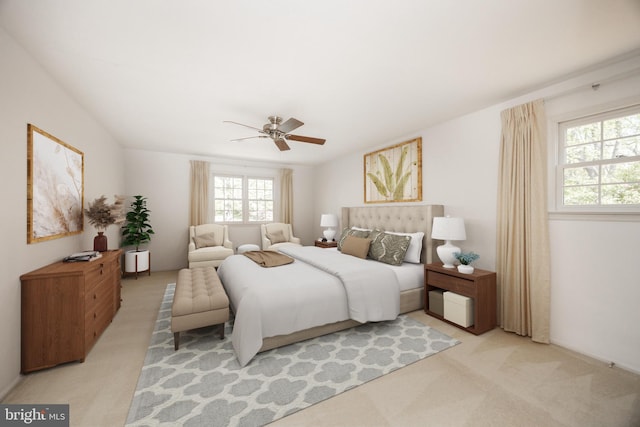 bedroom with a ceiling fan, multiple windows, and light carpet