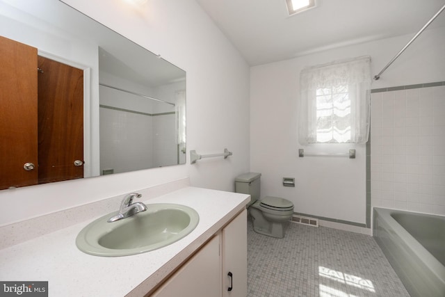 full bathroom featuring tile patterned flooring, toilet, vanity, visible vents, and washtub / shower combination