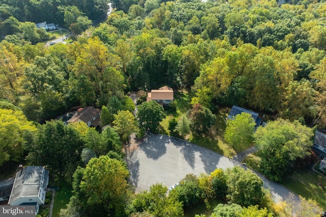 birds eye view of property with a forest view