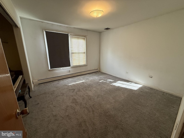 unfurnished bedroom with a closet, carpet floors, visible vents, and baseboard heating