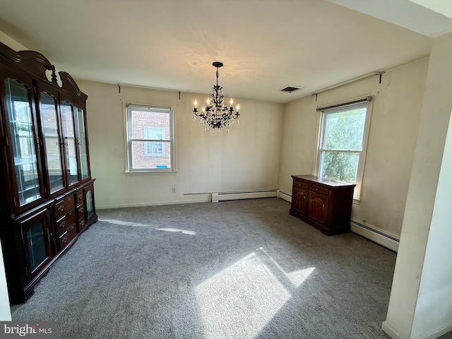 unfurnished dining area featuring a baseboard radiator, an inviting chandelier, carpet flooring, and visible vents
