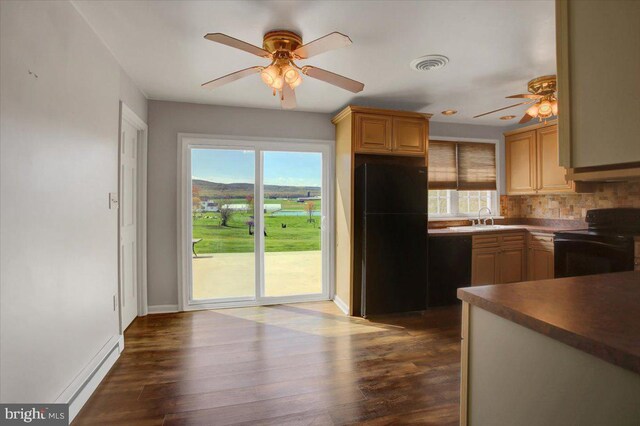 2284 Pine Rd, Newville, PA 17241 - kitchen featuring dark wood-type flooring, decorative backsplash, ceiling fan, and black appliances