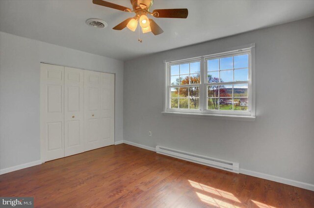 2284 Pine Rd, Newville, PA 17241 - unfurnished bedroom featuring a baseboard radiator, baseboards, wood finished floors, and visible vents