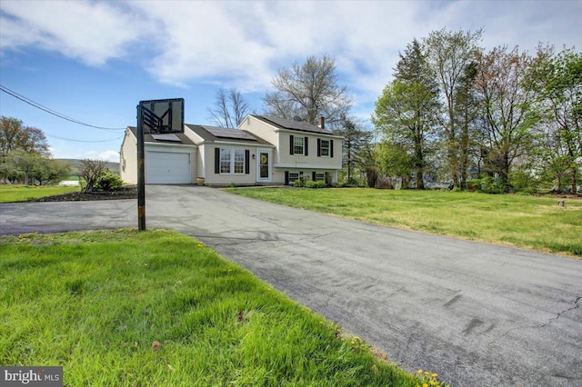 2284 Pine Rd, Newville, PA 17241 - split level home featuring solar panels, driveway, a garage, and a front yard