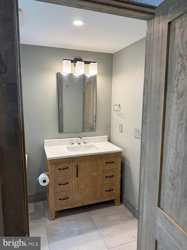bathroom featuring tile patterned floors, vanity, recessed lighting, and baseboards