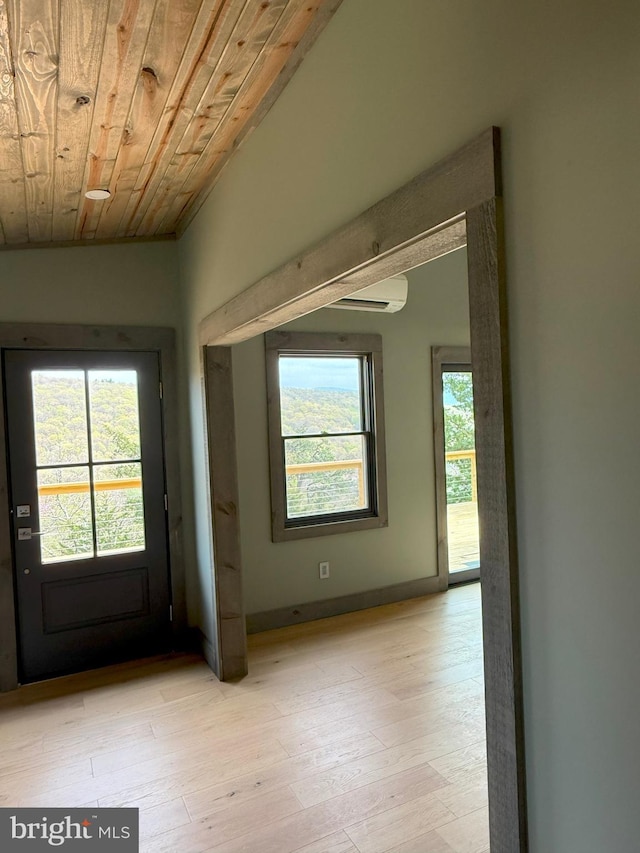 doorway to outside featuring light wood-type flooring and wood ceiling