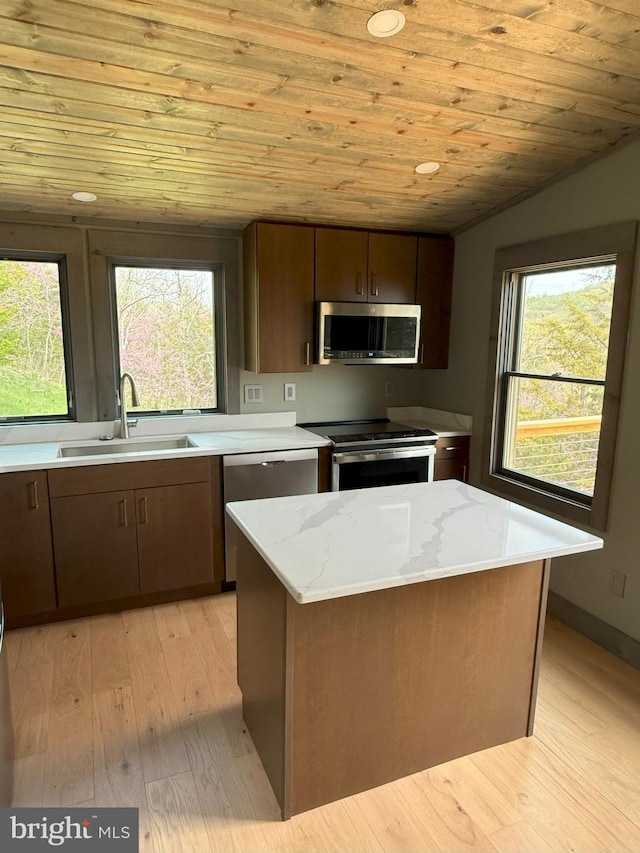 kitchen featuring a sink, wooden ceiling, light wood-style flooring, light stone counters, and appliances with stainless steel finishes