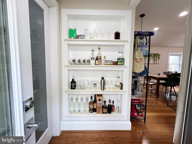 bar with recessed lighting, wood finished floors, and a dry bar