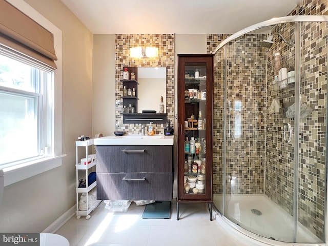 bathroom featuring tile patterned floors, a shower stall, and vanity