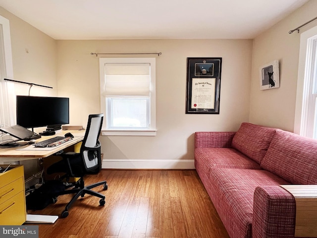 office with wood-type flooring and baseboards