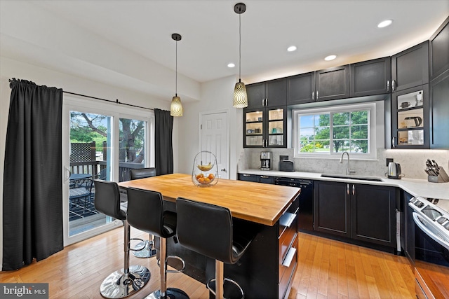 6780 Hollow Glen Ct, Gainesville, VA 20155 - kitchen with a sink, stainless steel range, butcher block counters, healthy amount of natural light, and recessed lighting