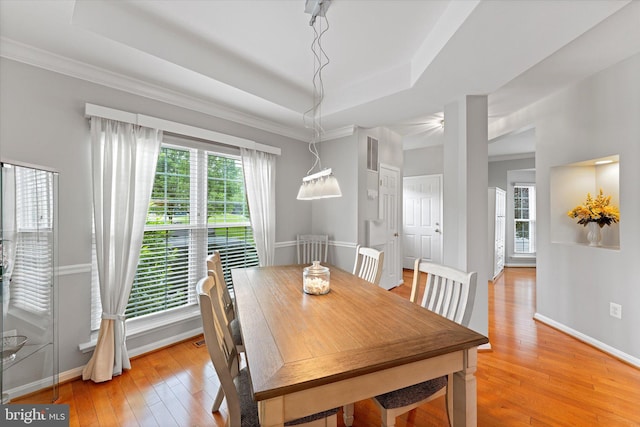 6780 Hollow Glen Ct, Gainesville, VA 20155 - dining space featuring a raised ceiling, light wood-style floors, and baseboards