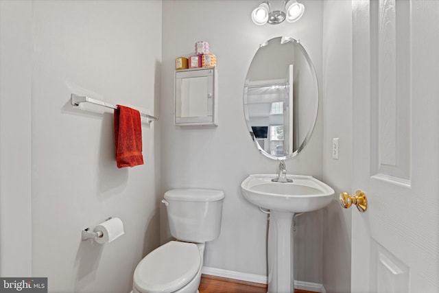 6780 Hollow Glen Ct, Gainesville, VA 20155 - half bathroom featuring toilet, baseboards, and a sink