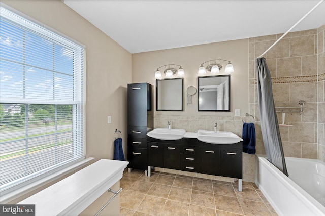 6780 Hollow Glen Ct, Gainesville, VA 20155 - bathroom with double vanity, shower / tub combo, plenty of natural light, tile walls, and tile patterned flooring