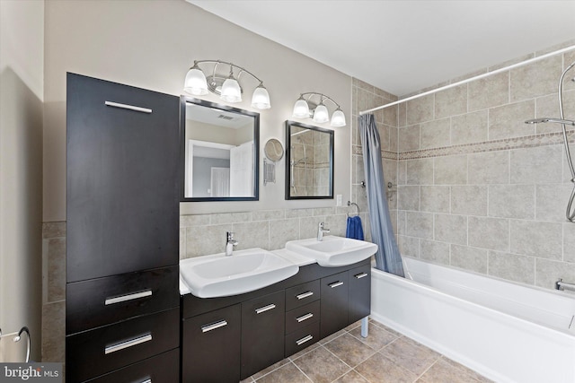 6780 Hollow Glen Ct, Gainesville, VA 20155 - full bathroom with shower / tub combo with curtain, double vanity, tile patterned floors, and tile walls