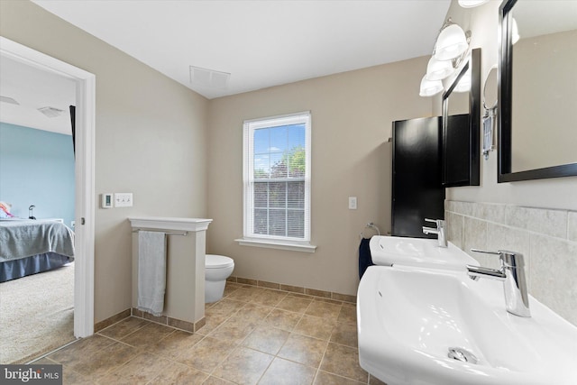 6780 Hollow Glen Ct, Gainesville, VA 20155 - ensuite bathroom featuring a sink, toilet, and baseboards