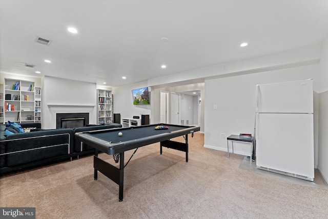 6780 Hollow Glen Ct, Gainesville, VA 20155 - rec room with light colored carpet, billiards table, recessed lighting, a glass covered fireplace, and built in shelves