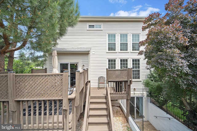 6780 Hollow Glen Ct, Gainesville, VA 20155 - rear view of house with stairway and a wooden deck