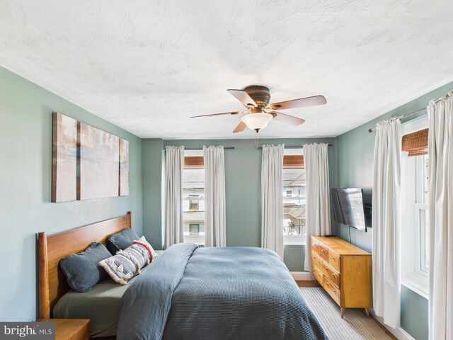 bedroom featuring ceiling fan and baseboards