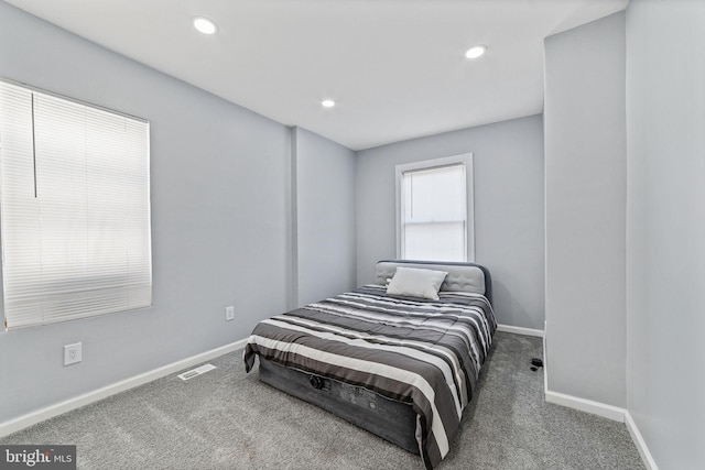 carpeted bedroom featuring visible vents, baseboards, and recessed lighting