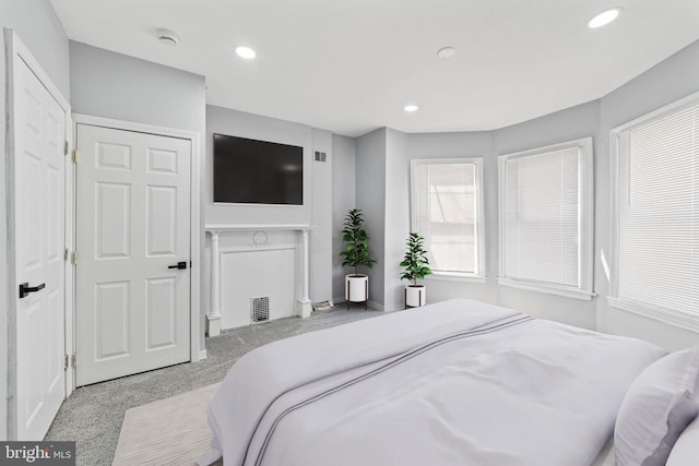 carpeted bedroom with recessed lighting, visible vents, and baseboards