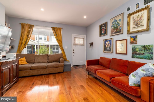 living area with visible vents, light wood finished floors, and recessed lighting