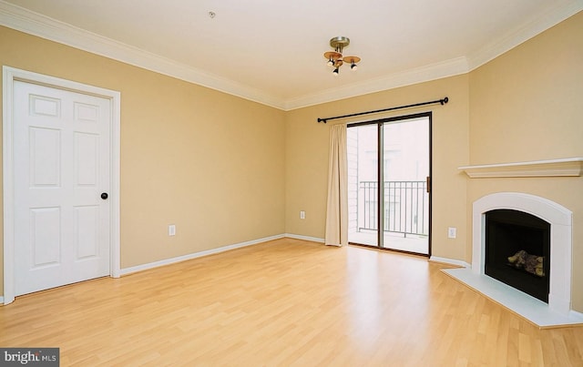 unfurnished living room featuring crown molding, a fireplace with raised hearth, light wood-style flooring, and baseboards