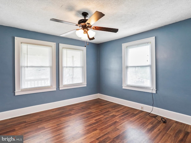 819 Manns Ter, Cumberland, MD 21502 - spare room featuring a ceiling fan, a textured ceiling, dark wood-style floors, and a healthy amount of sunlight