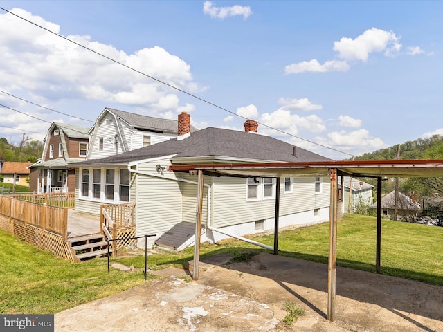819 Manns Ter, Cumberland, MD 21502 - rear view of house featuring a yard, a wooden deck, roof with shingles, and a chimney