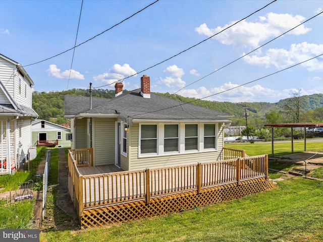 819 Manns Ter, Cumberland, MD 21502 - back of house featuring a lawn, a chimney, a deck with mountain view, and roof with shingles