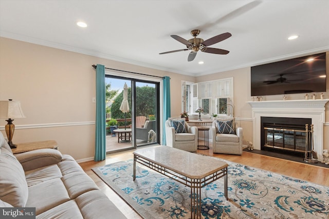 living room with ornamental molding, recessed lighting, a ceiling fan, and wood finished floors