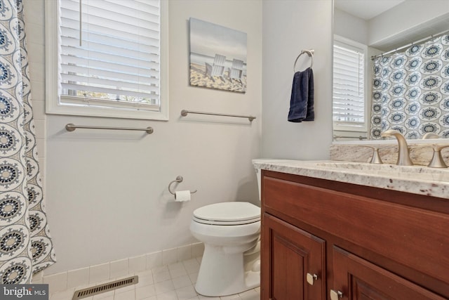 bathroom featuring curtained shower, visible vents, toilet, and vanity