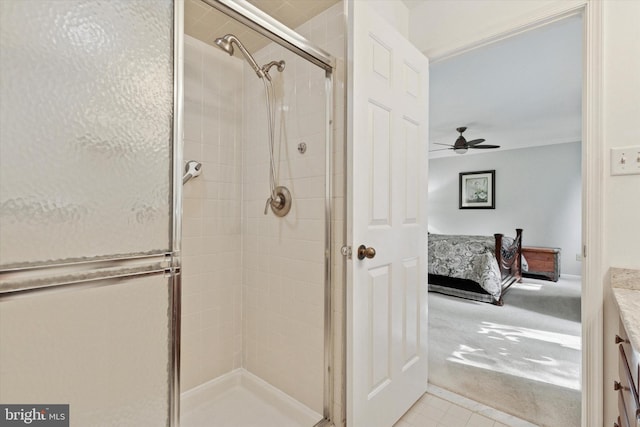 bathroom with ceiling fan, connected bathroom, tile patterned flooring, and a stall shower