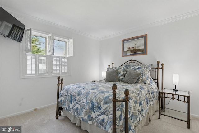 carpeted bedroom with baseboards and crown molding