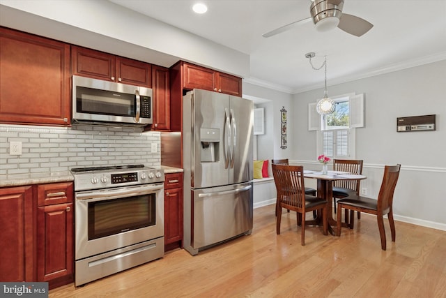 kitchen with light wood finished floors, dark brown cabinets, stainless steel appliances, and decorative backsplash