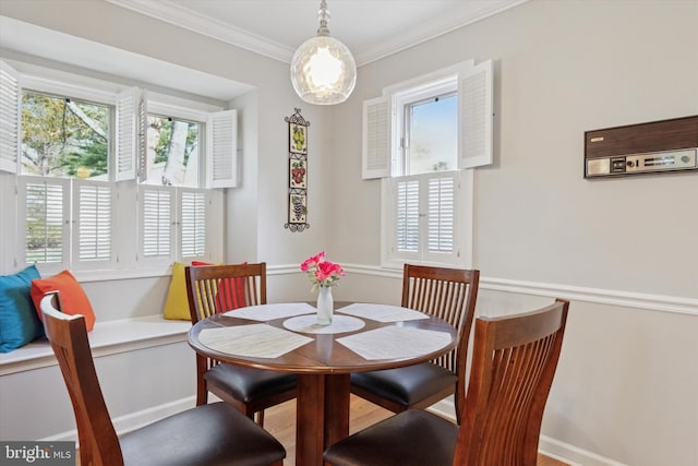 dining area featuring ornamental molding and baseboards