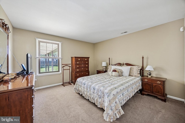 carpeted bedroom featuring baseboards and visible vents