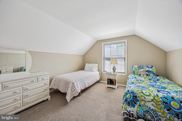 bedroom featuring baseboards, carpet flooring, and lofted ceiling