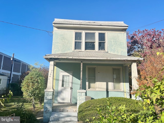 4304 Jay St NE, Washington, DC 20019 - view of front facade featuring a porch, fence, roof with shingles, and stucco siding