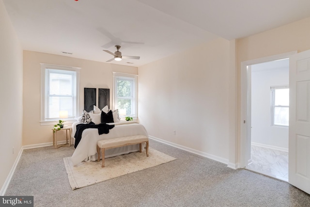 bedroom with carpet flooring, a ceiling fan, baseboards, and visible vents