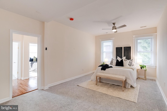 bedroom featuring baseboards, carpet, a ceiling fan, and visible vents