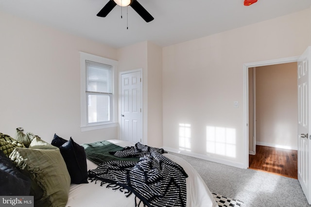 carpeted bedroom with a ceiling fan and baseboards