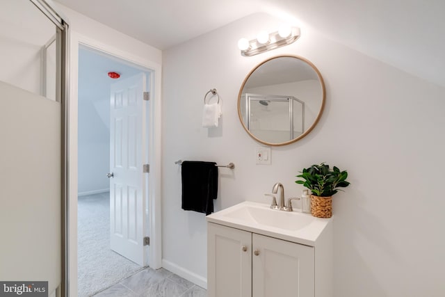 full bath featuring vanity, baseboards, and an enclosed shower