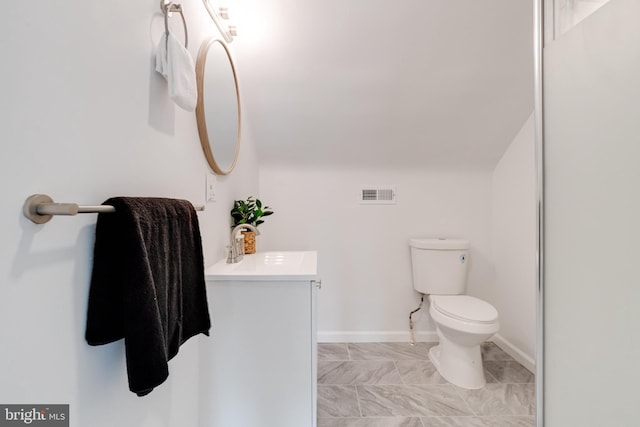 bathroom with vanity, toilet, tile patterned floors, baseboards, and visible vents
