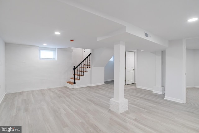 basement featuring recessed lighting, baseboards, wood finished floors, and stairway