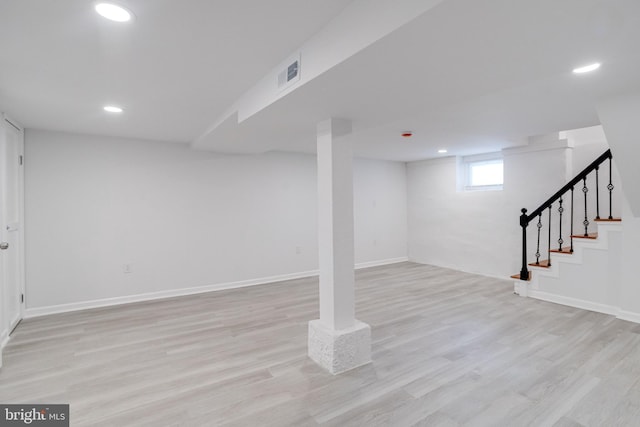 basement featuring light wood-type flooring, recessed lighting, and visible vents
